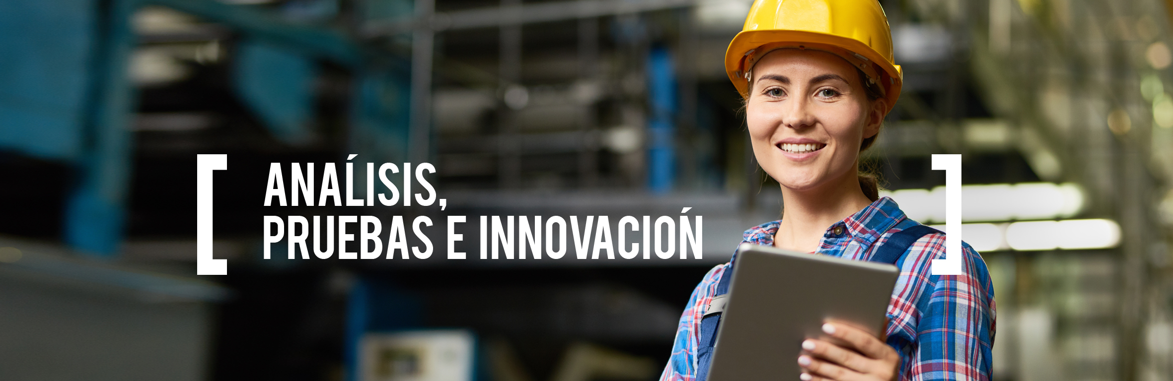A handsome engineer wearing a hard hat in the control room